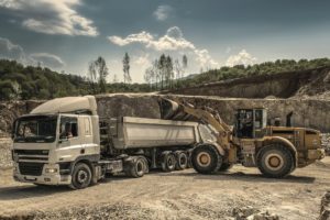 What Is Moly Grease? 14 Excavator loading a semi truck.