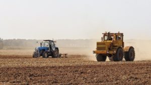 Tractor tilling soil.