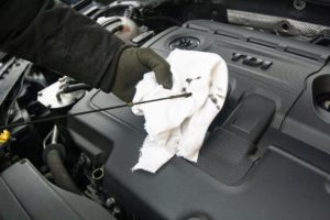 Changing the oil in a car.