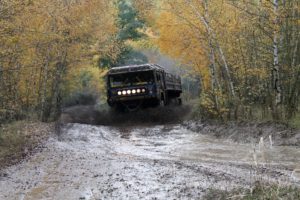 Synthetic Marine Wheel Bearing Grease 12 Large truck driving on wet road.