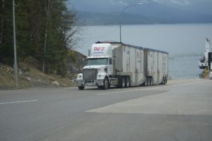 Large semi truck near lake.