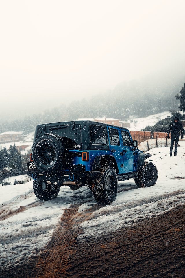 Featured image for "Can I Put Synthetic Oil in My Car After Using Regular Oil?" blog post. Blue Jeep.