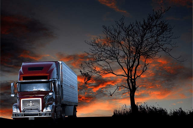 Featured image for "The Battle of Titans: Kenworth* vs Peterbilt* vs Freightliner*" blog post. Semi truck at sunset.