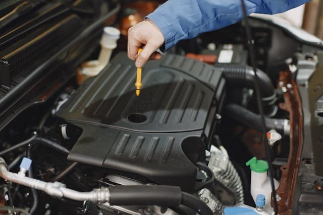 Featured image for "Debunking the 3,000-Mile Oil Change Myth" blog post. Changing oil.