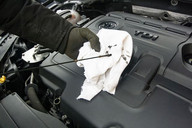 Featured image for "Engine Oil Analysis: Your Secret Weapon for Preventive Maintenance" blog post. Oil dipstick.