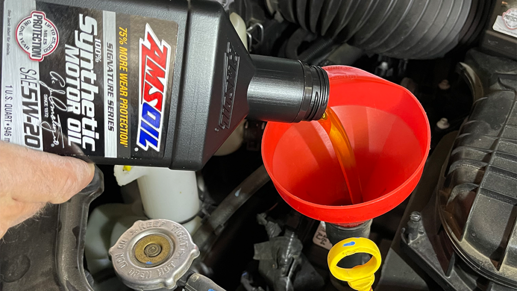 Featured image for "5 No-No’s of DIY Oil Change [Avoid These Costly Errors]" blog post. AMSOIL oil pouring.